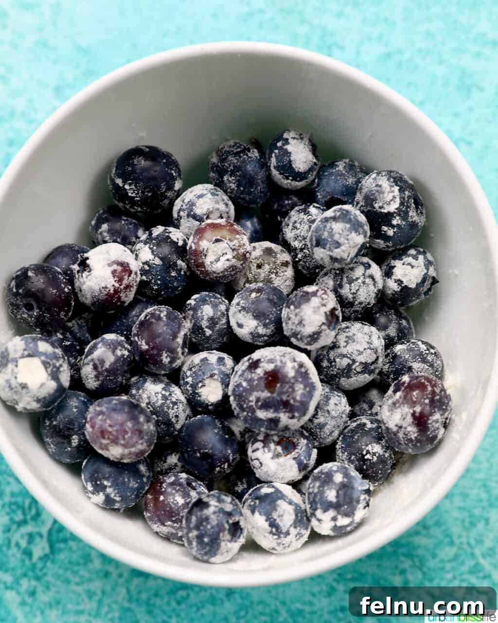 Blueberry Chocolate Chunk Muffins 7 Floured blueberries in a white bowl