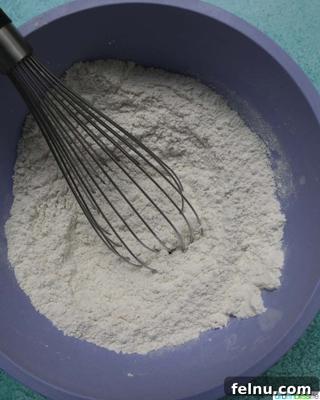 Blueberry Chocolate Chunk Muffins 8 Whisking dry ingredients in a purple bowl