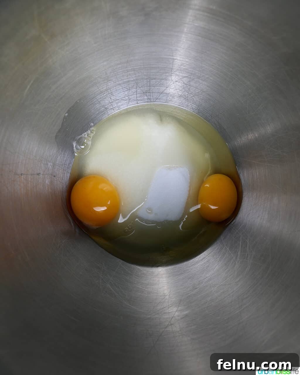 Blueberry Chocolate Chunk Muffins 9 Eggs and sugar being mixed in a stainless steel bowl