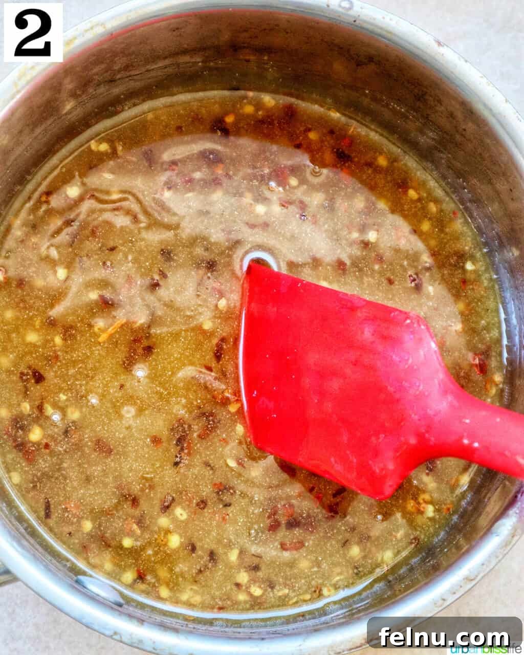 Hot Honey Sauce ingredients simmering gently in a saucepan.