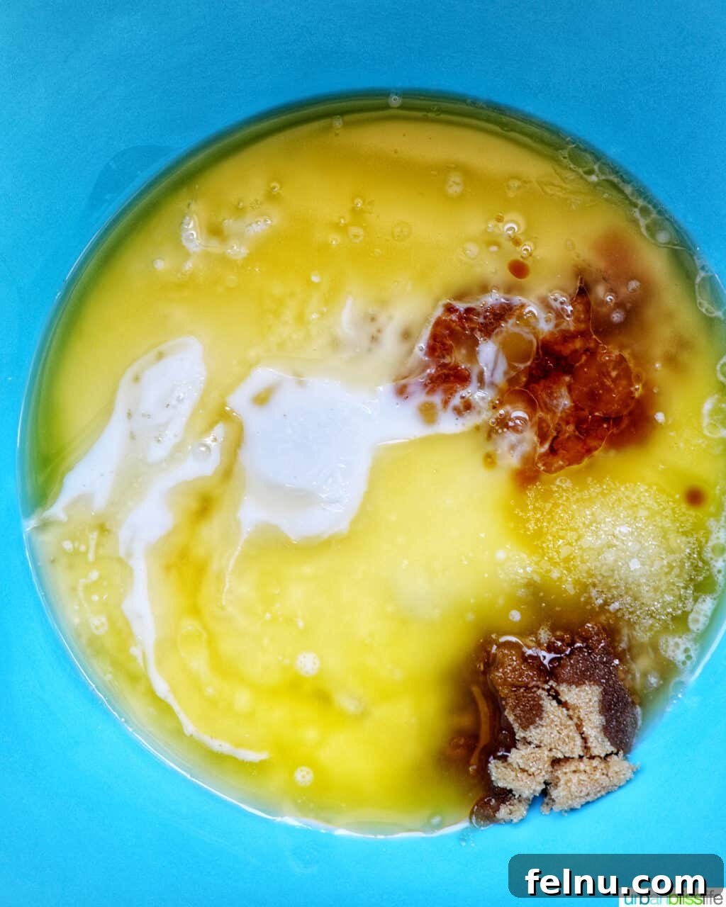 Wet baking ingredients in a blue bowl.