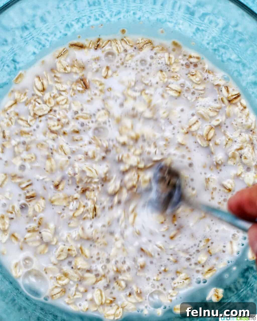 Bursting Blackberry Banana Oat Muffins 5 A bowl containing a mixture of milk and oats, prepared for soaking.
