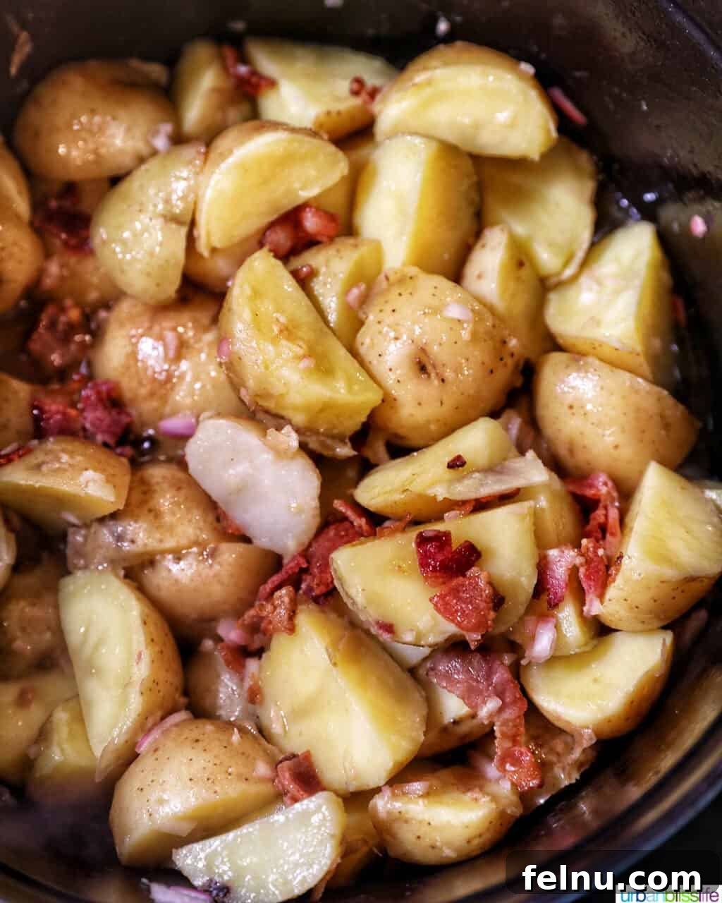 Creamy Baby Potato Salad with Crispy Bacon 11 mixing baby potato salad with bacon and dressing