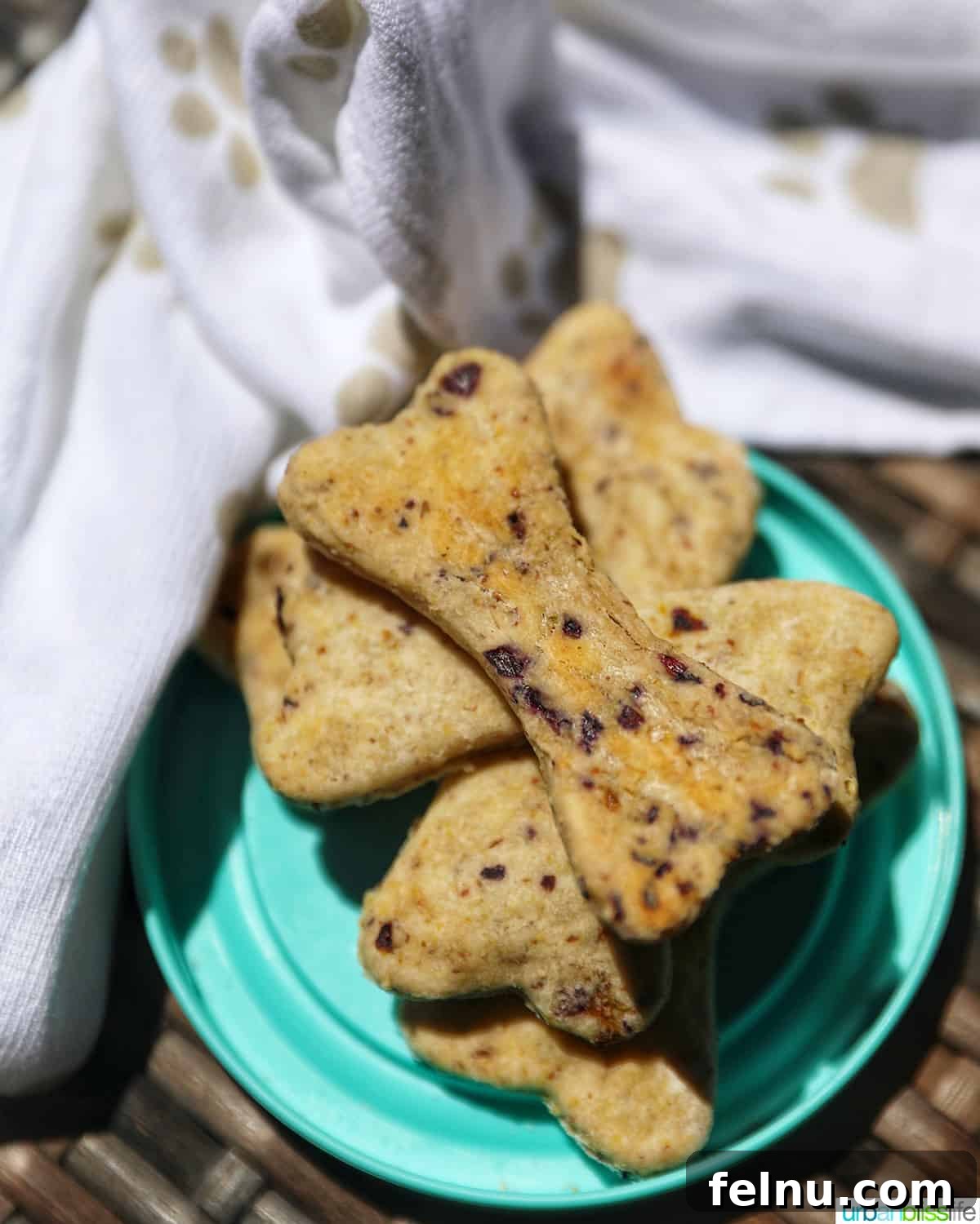 Happy Hound Blueberry Treats 14 Stack of three homemade blueberry dog treats with oats, shaped like dog bones.
