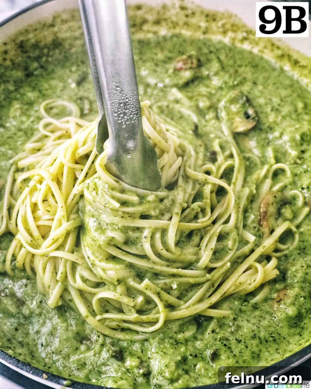Earthy Mushroom Pesto Pasta 15 Kitchen tongs expertly twirling linguine pasta in creamy mushroom pesto sauce, ensuring even coating.