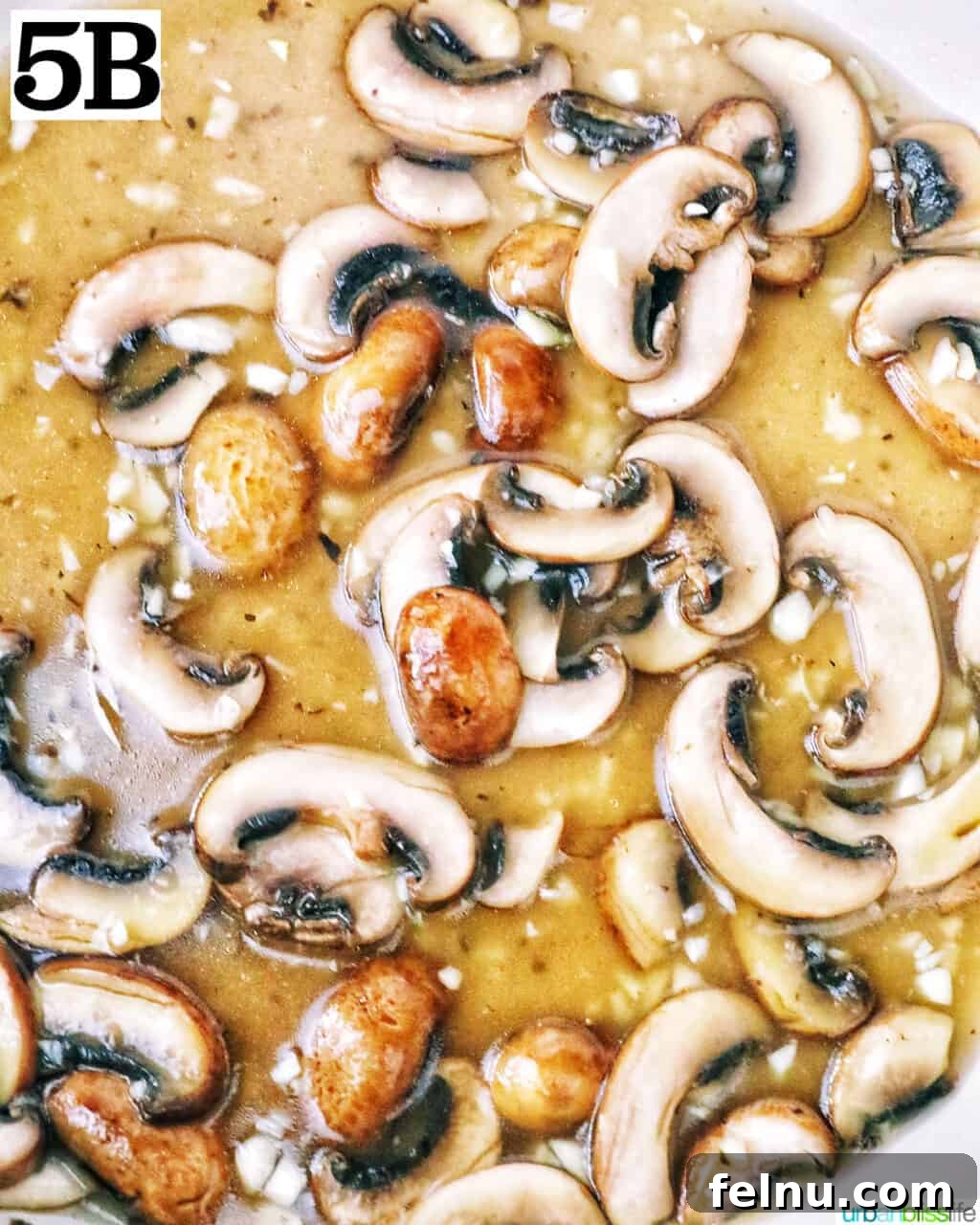 Earthy Mushroom Pesto Pasta 10 Sautéed mushrooms and garlic simmering in vegetable broth in a pan.