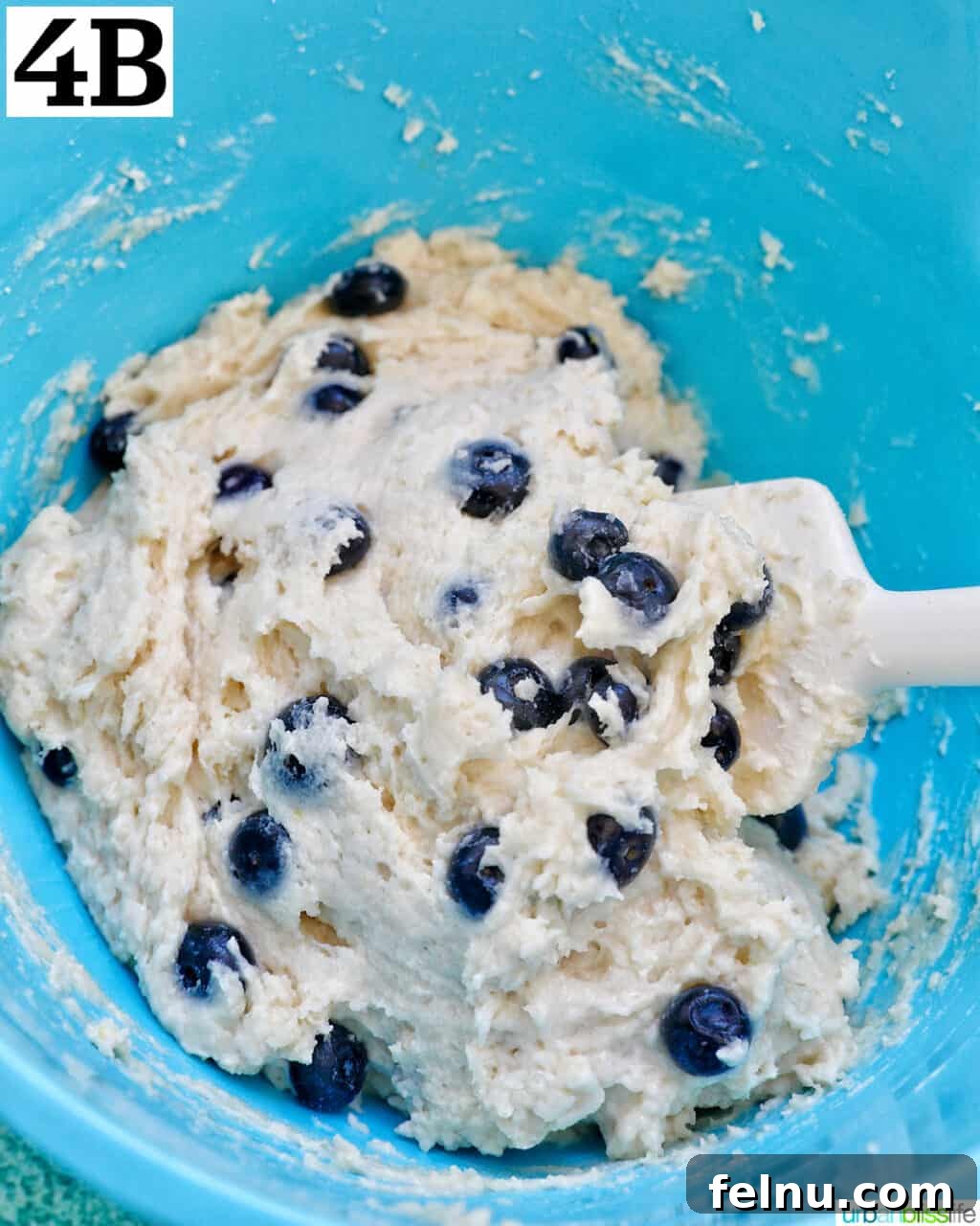 Lemon Blueberry Bliss Cookies 12 Folding blueberries into dough to make lemon blueberry cookies.