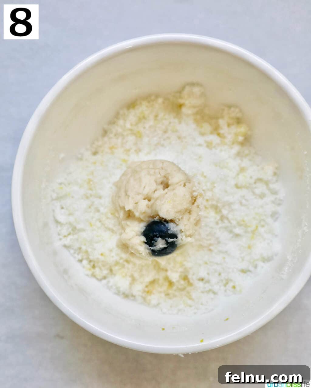 Lemon Blueberry Bliss Cookies 17 Lemon blueberry cookie dough ball in lemon sugar.