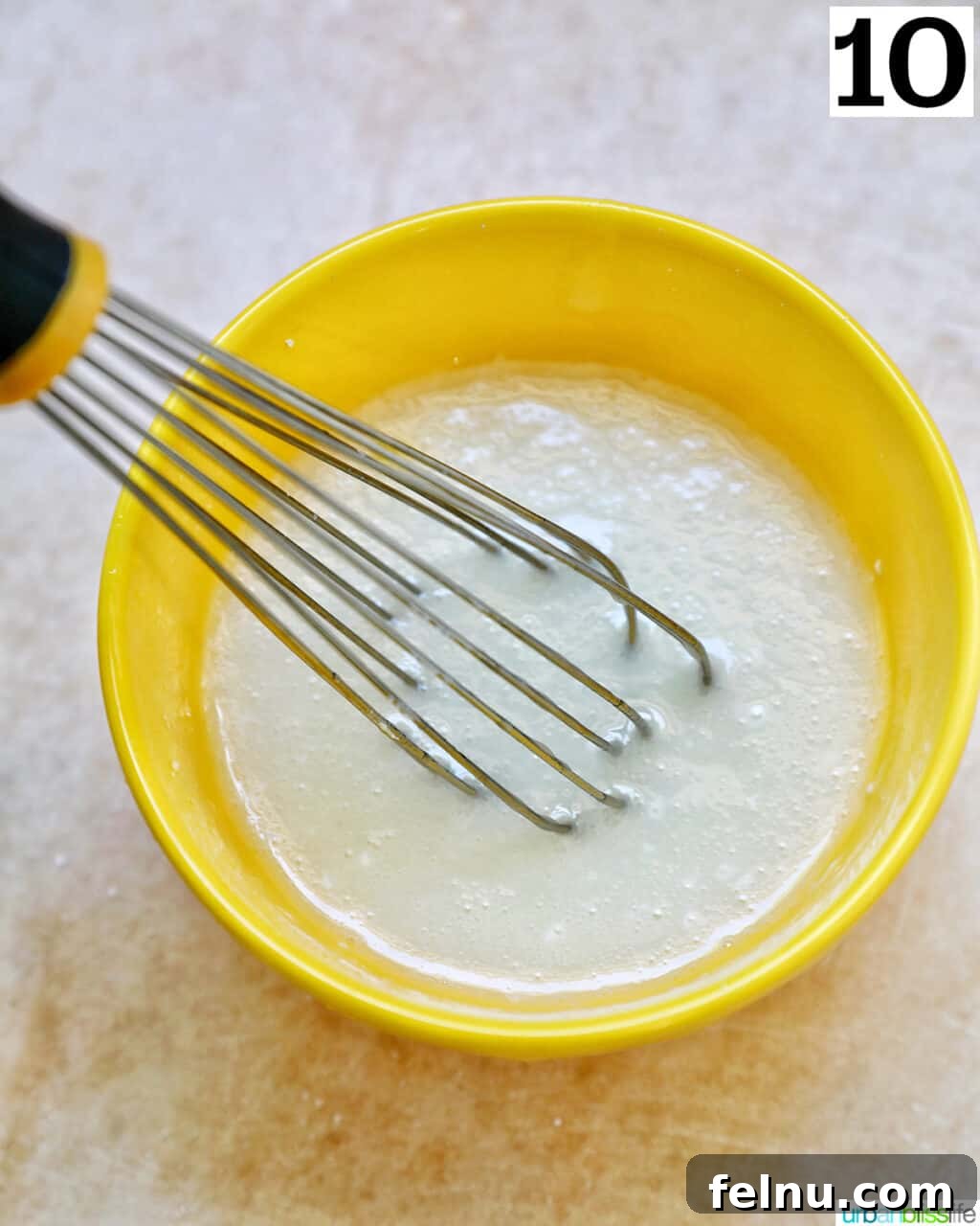 Lemon Blueberry Bliss Cookies 19 Whisk in lemon glaze in a yellow bowl.