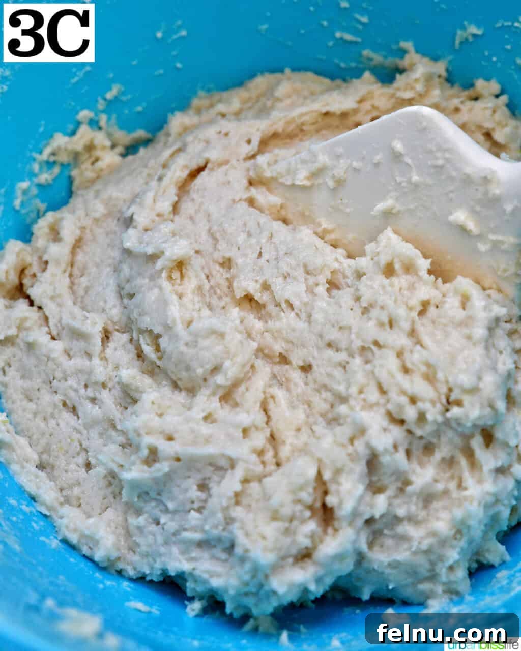 Lemon Blueberry Bliss Cookies 10 Dough in a blue bowl to make lemon blueberry cookies.