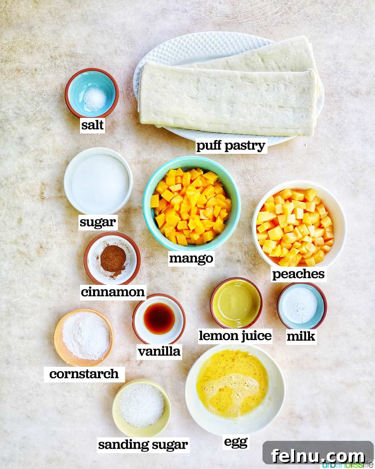 Sun-Kissed Peach Mango Pie 4 Bowls of ingredients to make peach mango pie Jollibee copycat recipe, including diced fruit, sugar, and cinnamon.