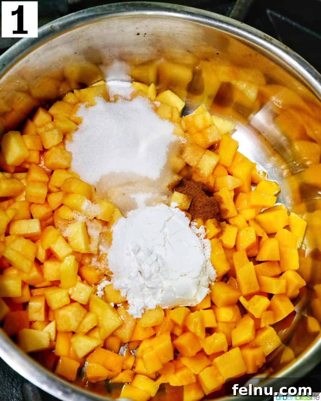 Sun-Kissed Peach Mango Pie 5 Diced peaches and mangoes with cornstarch and cinnamon in a saucepan, ready for cooking.