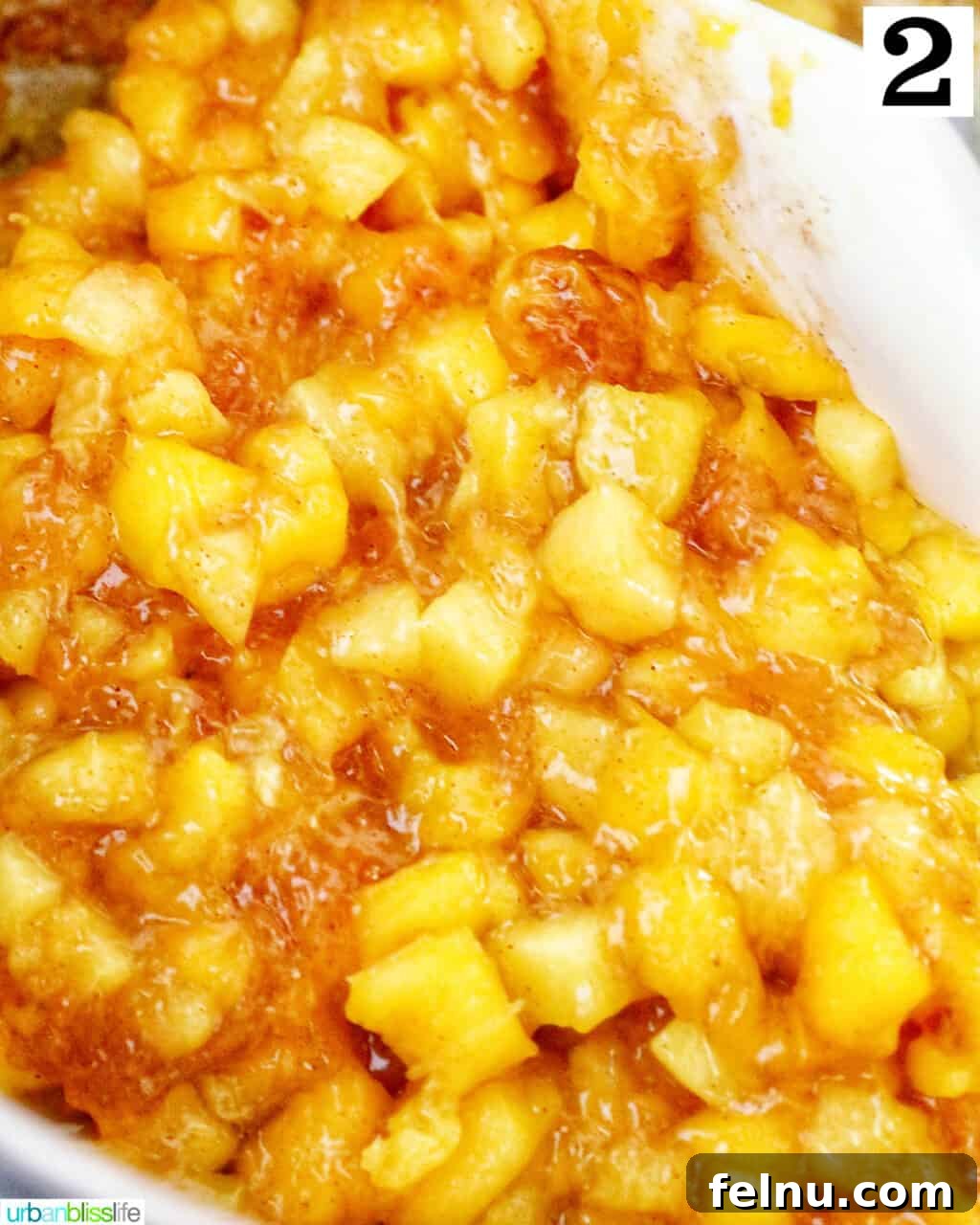 Sun-Kissed Peach Mango Pie 6 Diced mangoes and peaches cooking in a saucepan, thickening into a vibrant fruit filling.