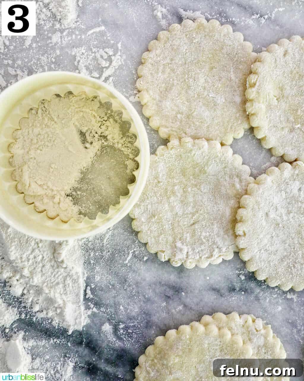 Sun-Kissed Peach Mango Pie 7 A round cookie cutter pressing into puff pastry dough, creating perfect circles.