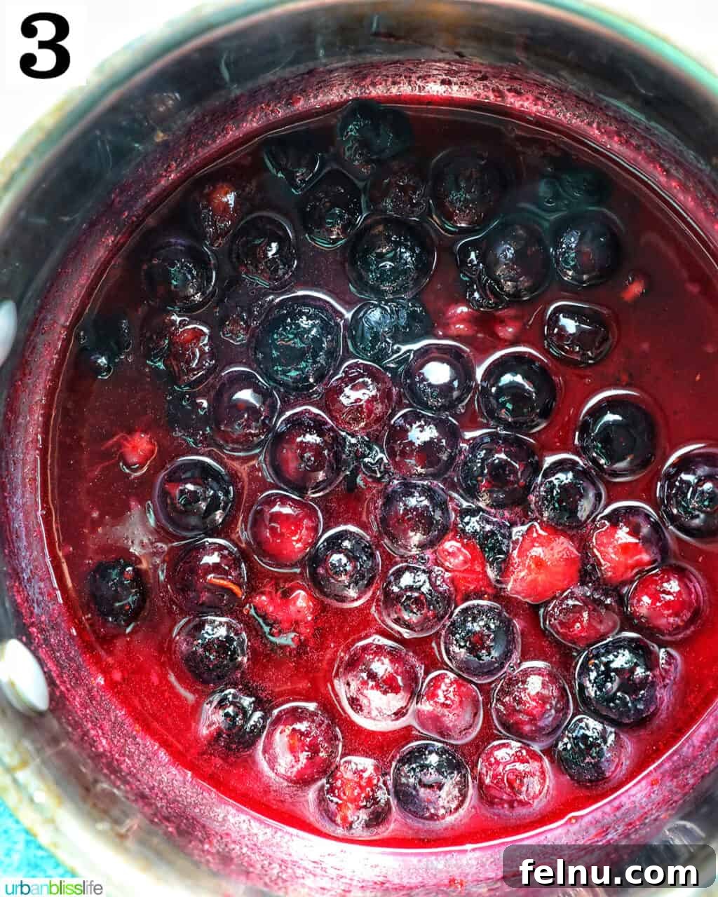 Blueberry Bliss Toast 7 Thickened blueberry compote in a saucepan, vibrant and glossy.