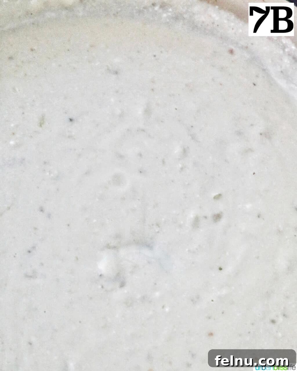 Velvety Salmon Pasta 14 A close-up view of the rich, thick cream sauce simmering gently in a large skillet, ready for the pasta.