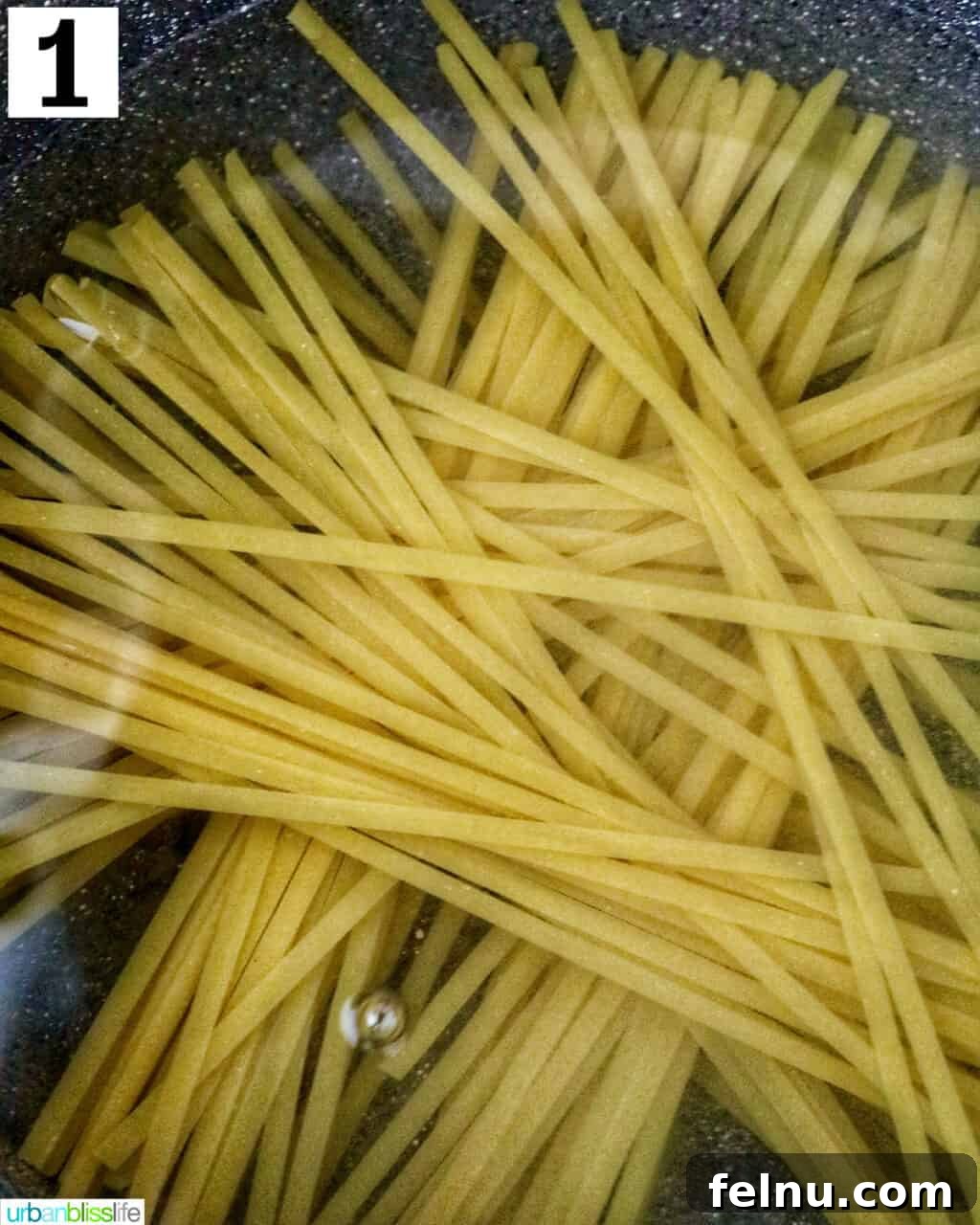Velvety Salmon Pasta 5 Pasta cooking in a large pot of boiling water, steam gently rising.