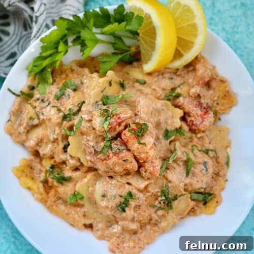 Tuscan Shrimp Gnocchi Delight 22 lobster ravioli sauce with lobster meat, lemon wedges, and herbs in a white bowl.