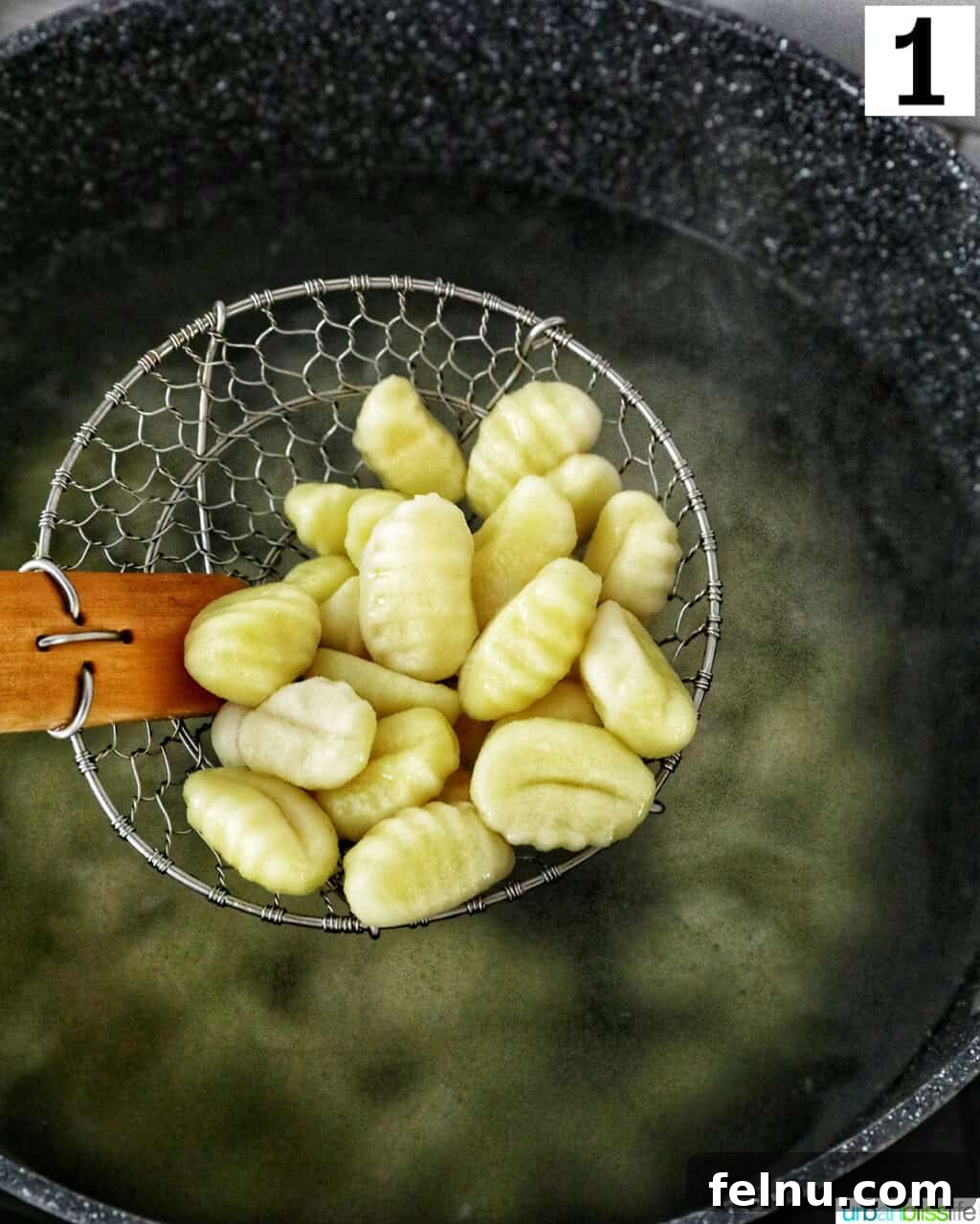 Tuscan Shrimp Gnocchi Delight 5 Gnocchi being boiled in a pot of water.
