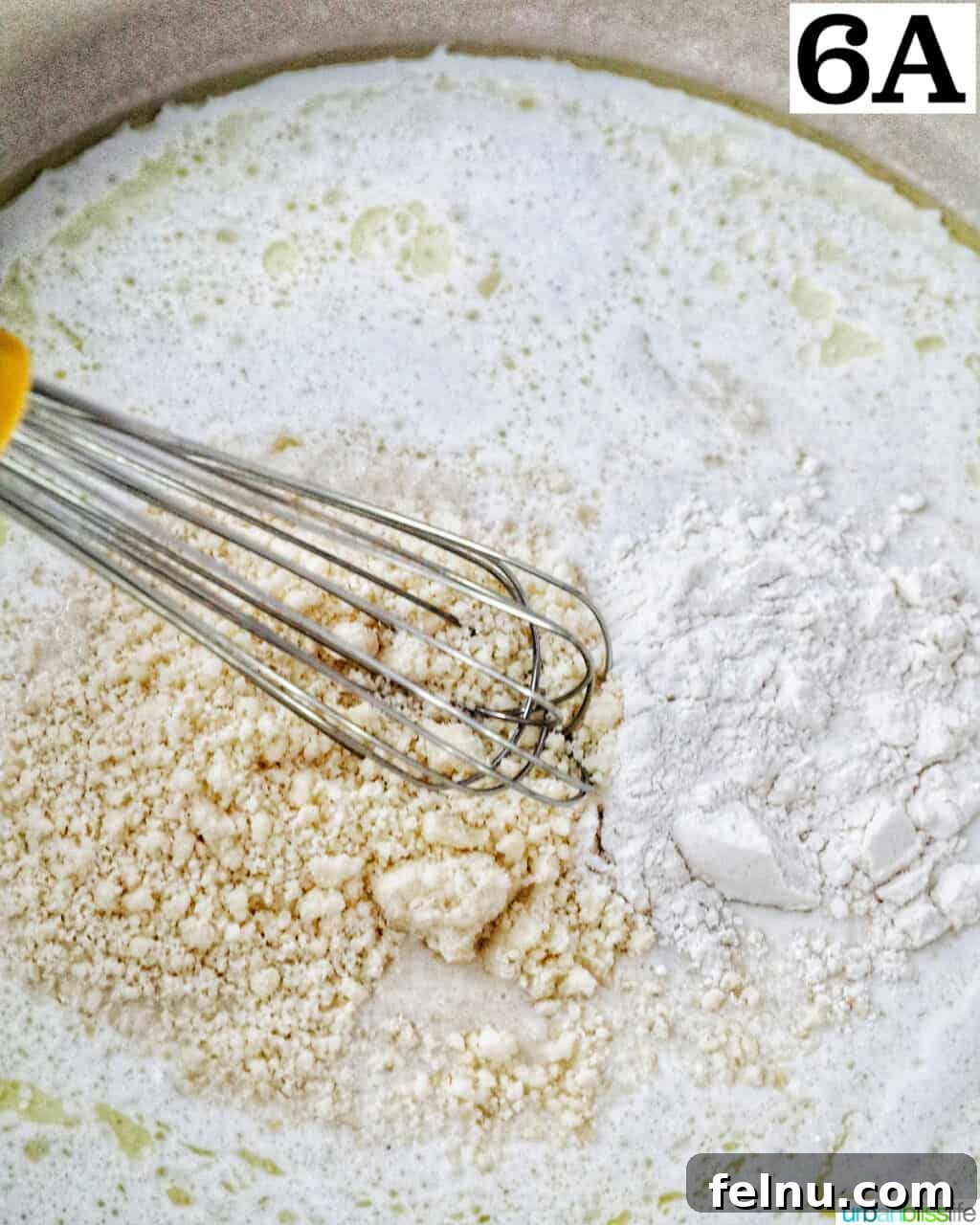 Tuscan Shrimp Gnocchi Delight 10 Parmesan cheese being stirred into the sauce.