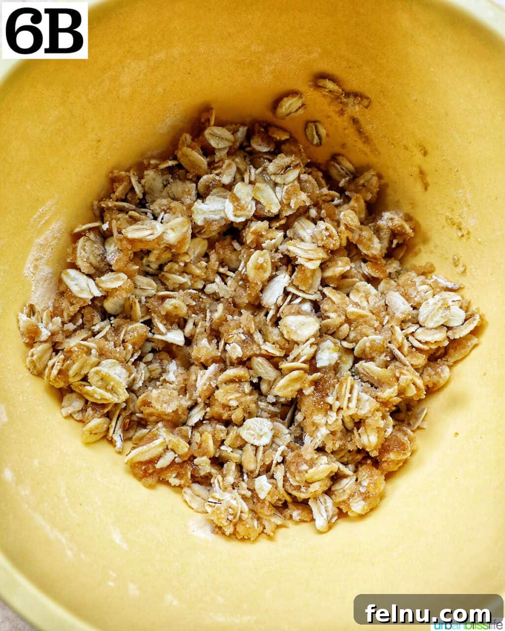 Air Fryer Apple Crumble 12 Yellow bowl with oats, sugar, and flour to make a streusel topping.