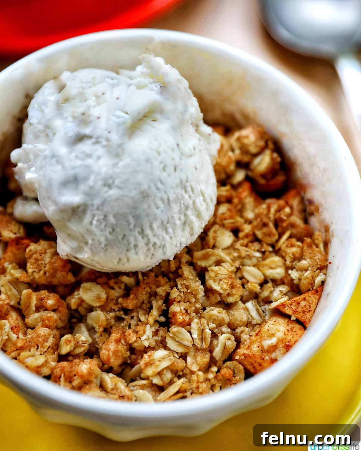 Air Fryer Apple Crumble 16 Bowl of Air Fryer Apple Crisp with scoop of ice cream.