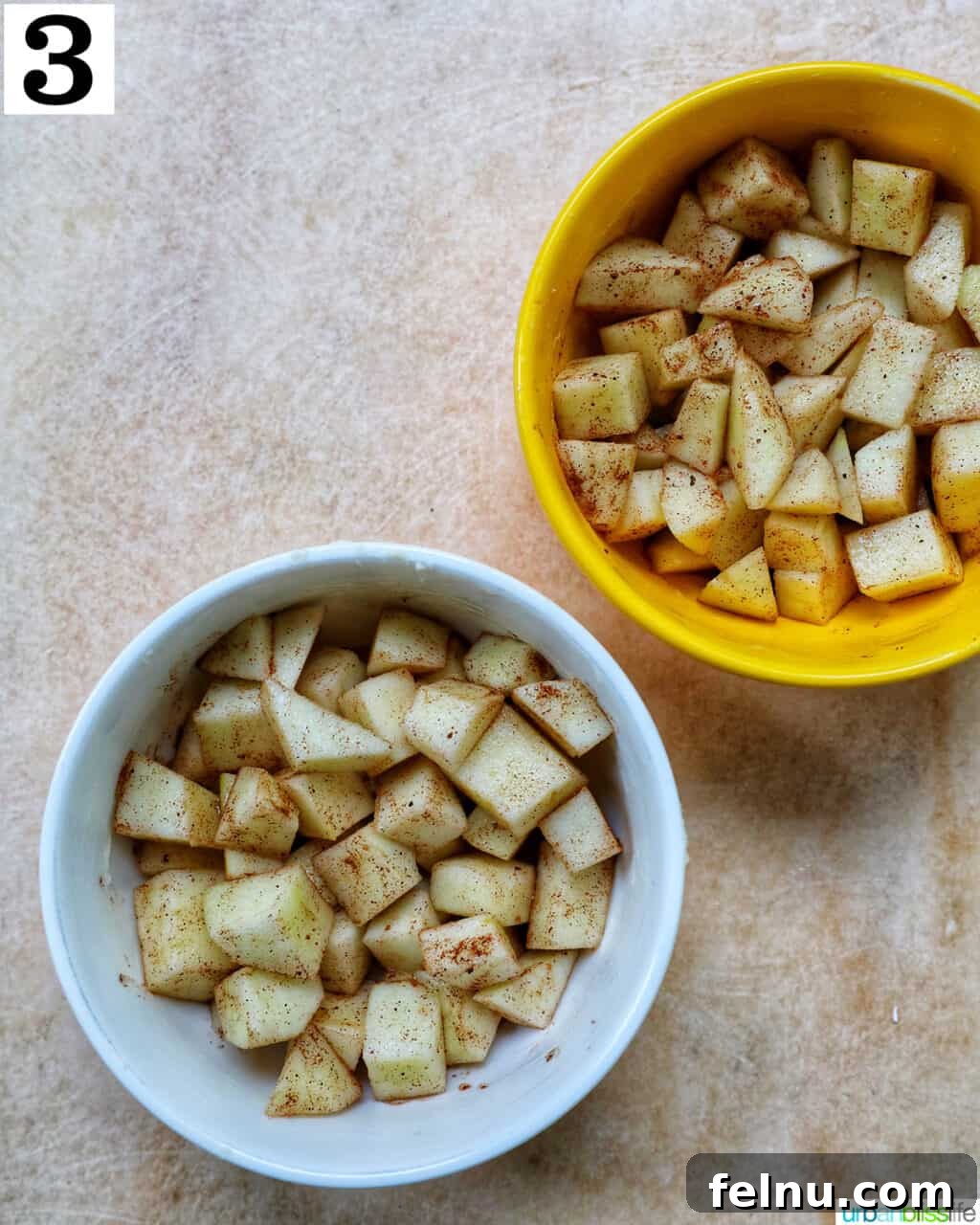 Air Fryer Apple Crumble 8 Two bowls with seasoned diced apples in them.