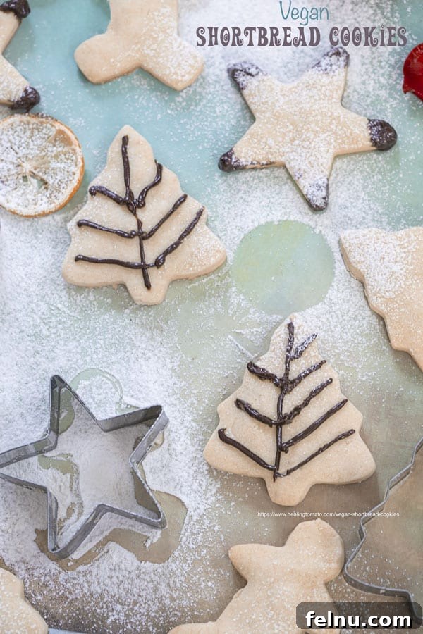 Buttery, flaky vegan shortbread cookies on a white surface.