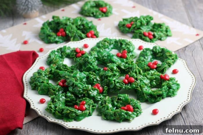 Christmas wreath cookies made with green cornflakes and red candies.
