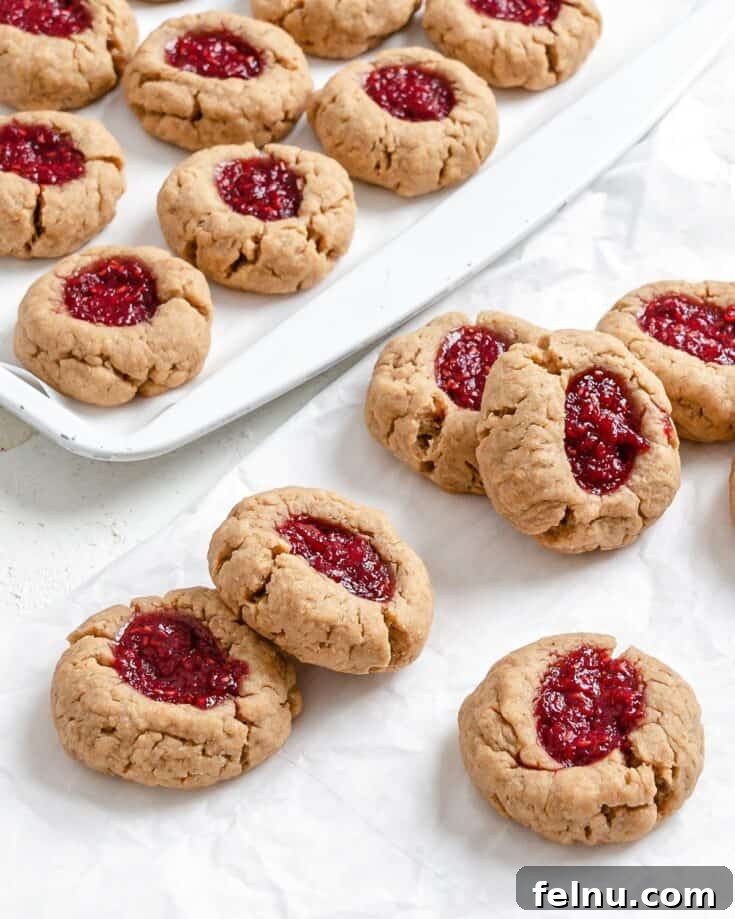 Vegan peanut butter and jelly thumbprint cookies with jam filling.
