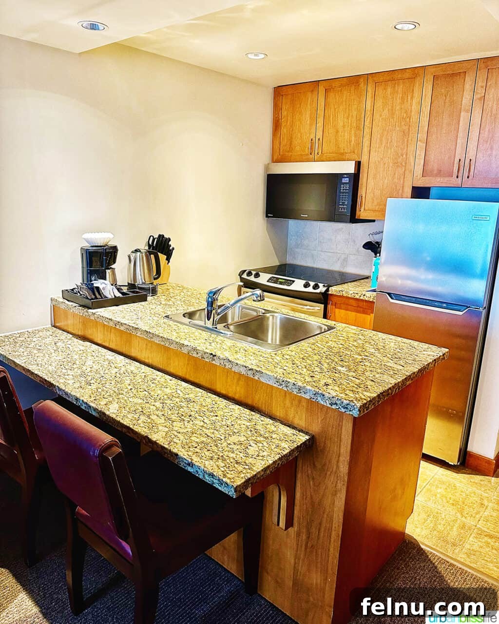 Whistler Village Signature Escape 4 Fully equipped kitchenette with modern appliances in a suite at the Pan Pacific Whistler Village Centre Hotel, perfect for preparing meals.