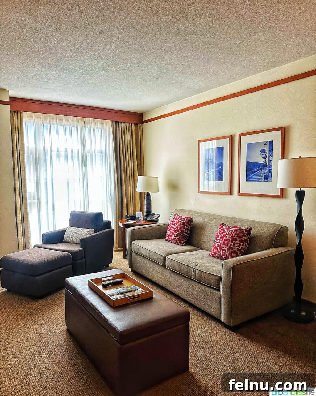 Whistler Village Signature Escape 5 Comfortable and elegantly furnished living area of a one-bedroom suite at the Pan Pacific Whistler Village Centre Hotel, featuring a gas fireplace.