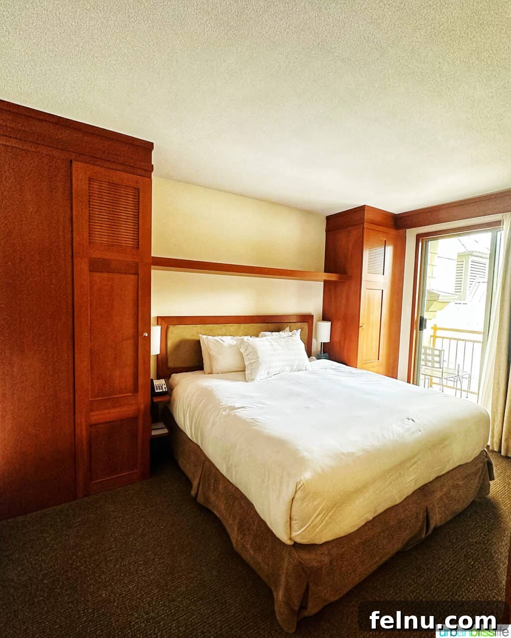 Whistler Village Signature Escape 6 Cozy king-sized bed in the separate bedroom of a one-bedroom suite at Pan Pacific Whistler Village Centre Hotel, designed for restful sleep.