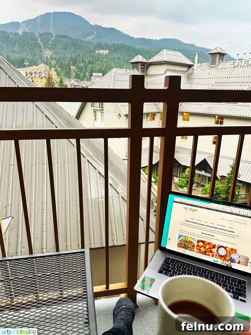 Whistler Village Signature Escape 8 Spacious private balcony with seating, offering stunning views of Whistler Village and the surrounding mountains from a suite at Pan Pacific Whistler Village Centre Hotel.