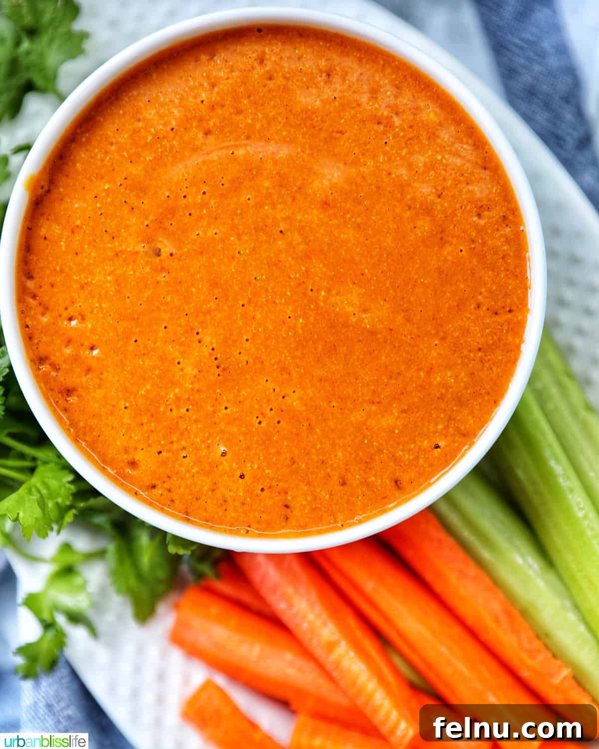 Vegan buffalo sauce served with carrot and celery sticks
