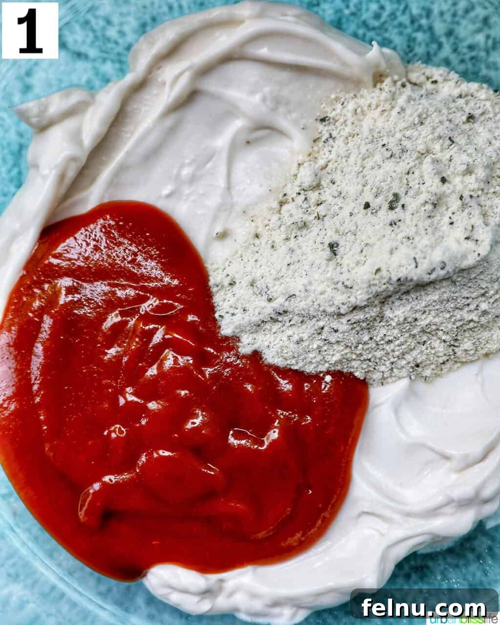 Ingredients in a bowl for Buffalo Ranch Sauce.