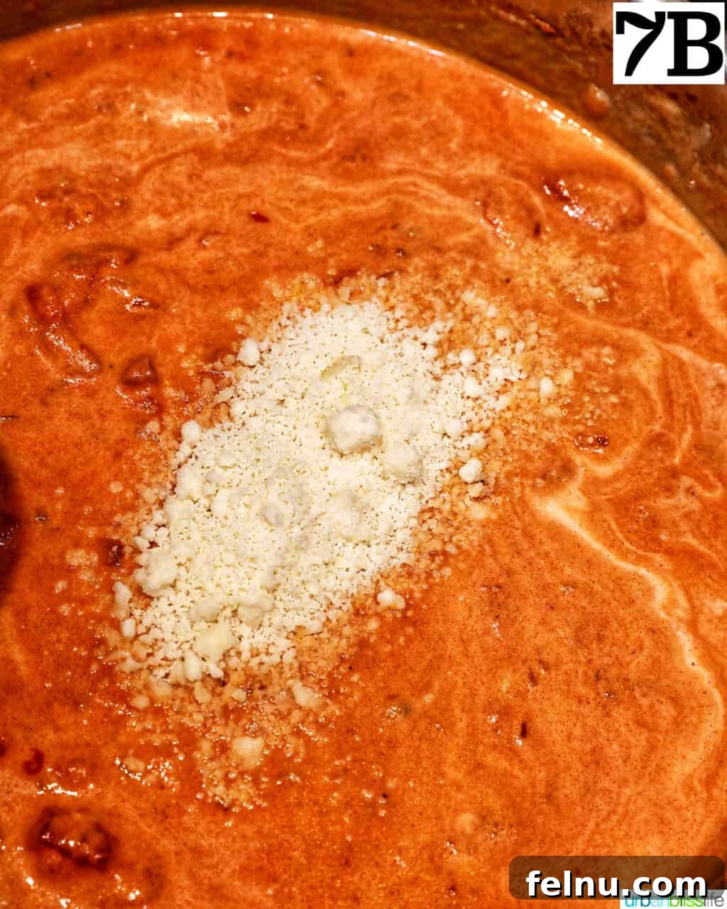 Creamy Dreamy Rigatoni: A Vodka Sauce Delight 13 Adding parmesan cheese