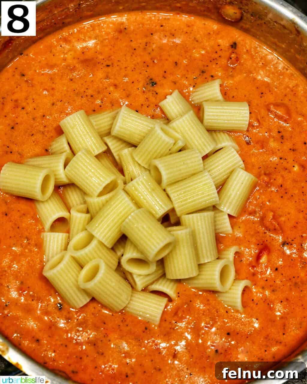 Creamy Dreamy Rigatoni: A Vodka Sauce Delight 15 Adding rigatoni to the sauce