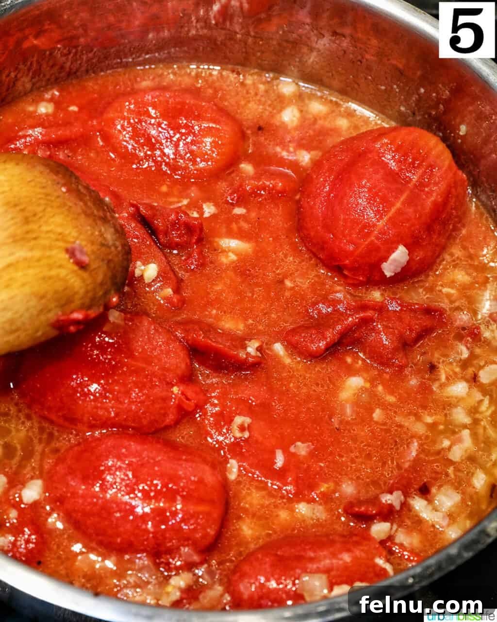 Creamy Dreamy Rigatoni: A Vodka Sauce Delight 10 Adding tomatoes to the sauce