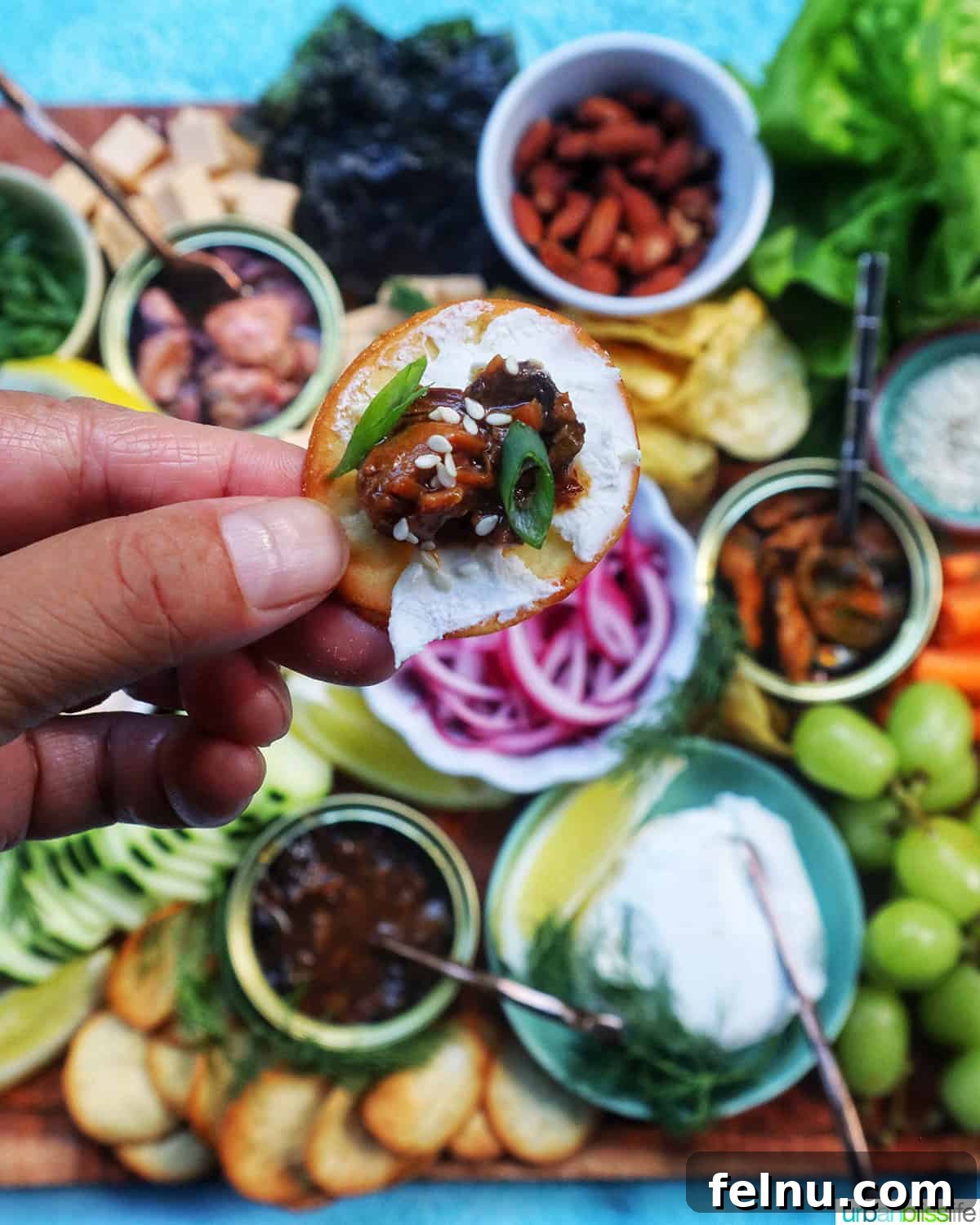 Someone holding a seacuterie board with various appetizers.