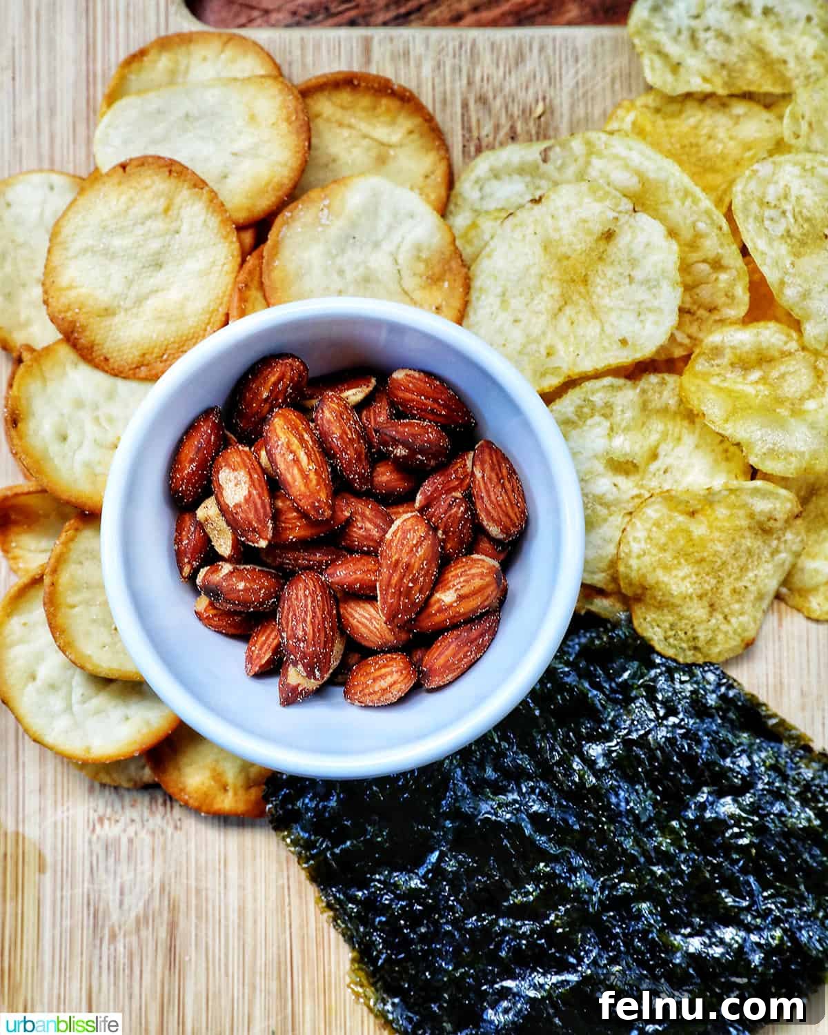 Assortment of chips, crackers, and nuts to create unique flavor combinations on a seacuterie board.