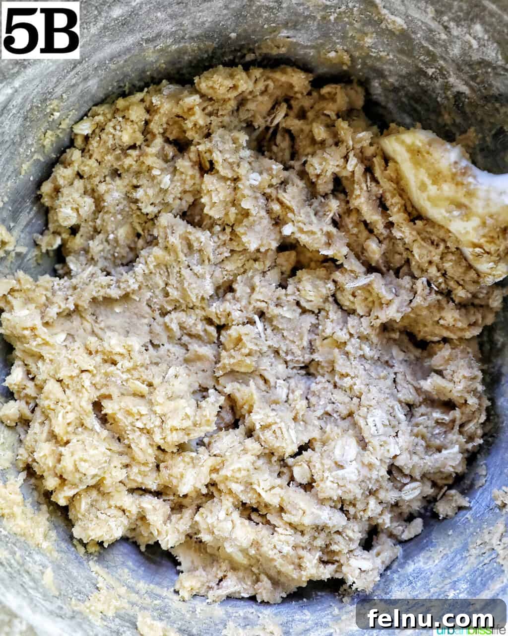 cookie batter dough mixed together in a stand mixer bowl.