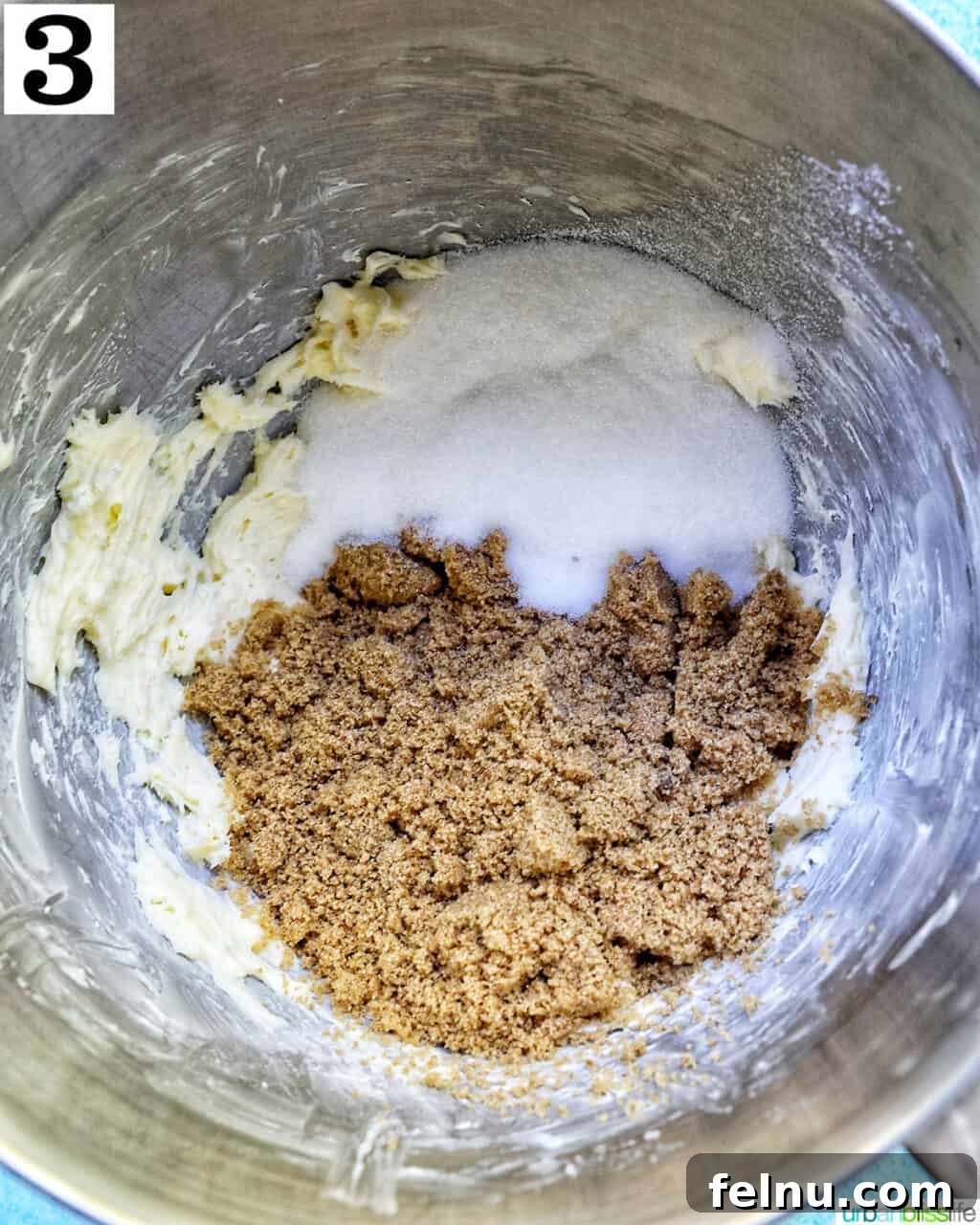 brown sugar and granulated sugar added to creamed butter in a stand mixer bowl.