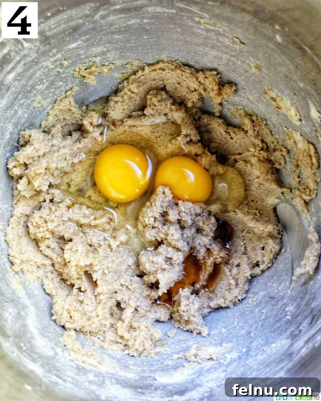 eggs added to wet batter in a stand mixer bowl.