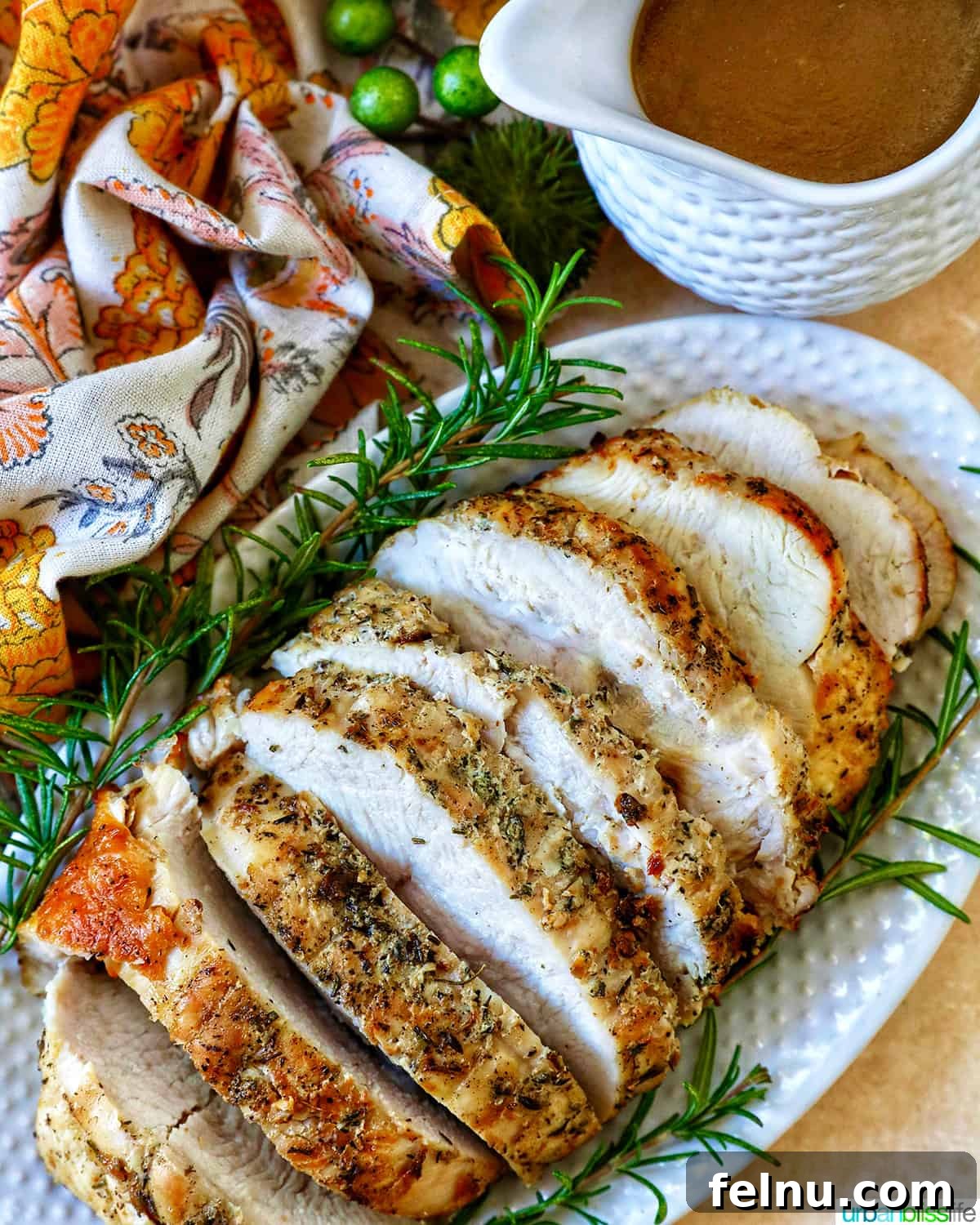 Crispy and Tender Air Fryer Turkey Breast 2 Perfectly sliced air fryer turkey breast with fresh herbs, ready to serve.