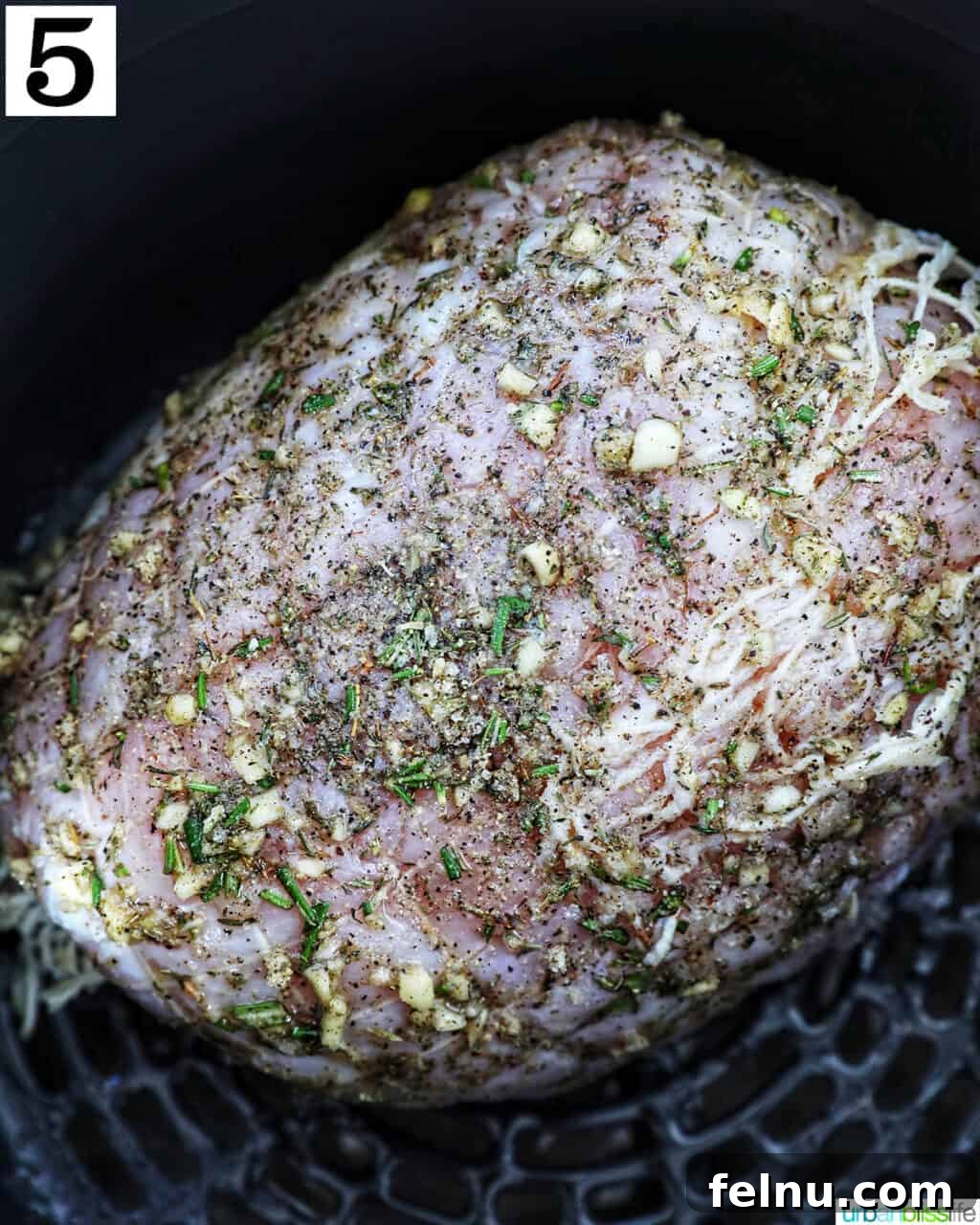 Crispy and Tender Air Fryer Turkey Breast 10 The seasoned turkey breast perfectly placed inside an air fryer basket, ready for cooking.