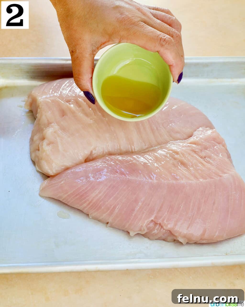 Perfect Air Fryer Turkey Tenderloin 6 Pouring a generous amount of olive oil over turkey tenderloins for coating.
