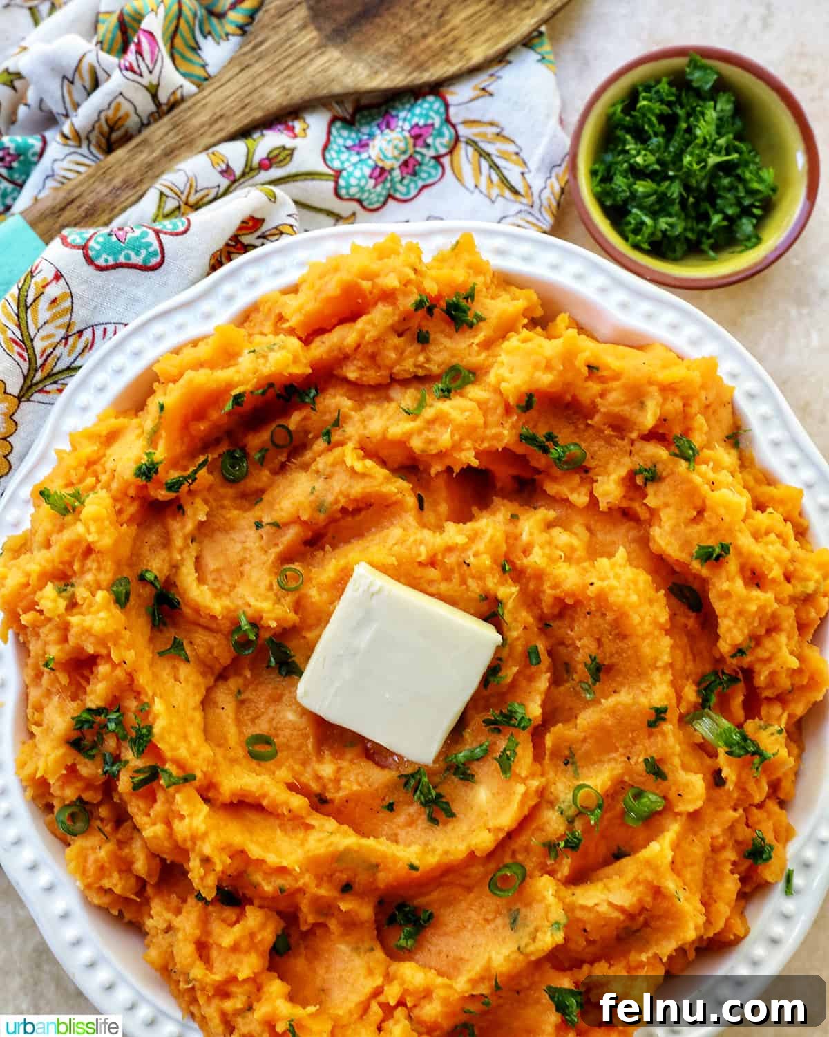 Silky Sweet Potato Puree 3 bowl of whipped sweet potatoes and a pat of butter with fresh herbs.