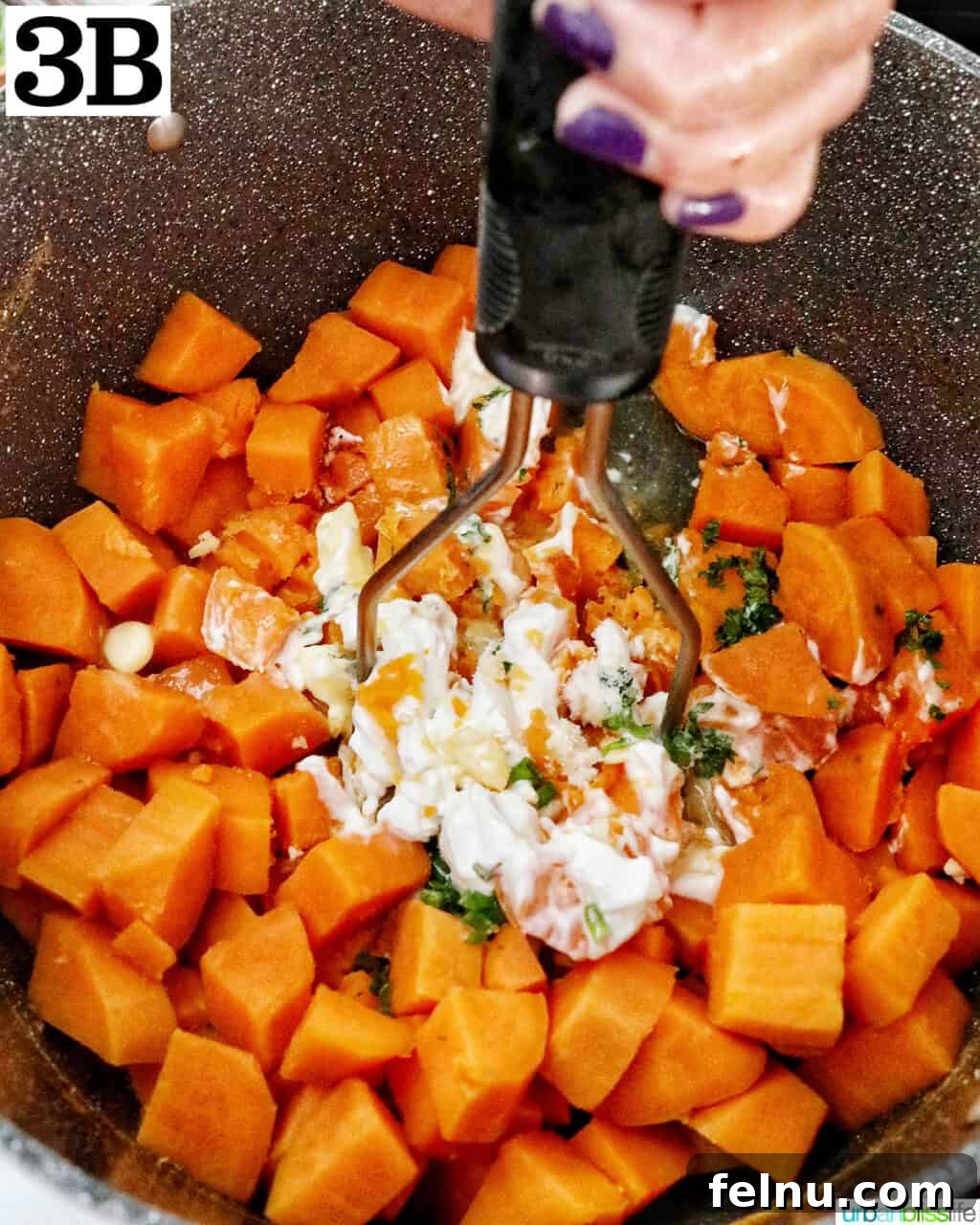 Silky Sweet Potato Puree 8 potato masher mashing sour cream, butter, garlic, and herbs into chopped sweet potatoes in a large pot.