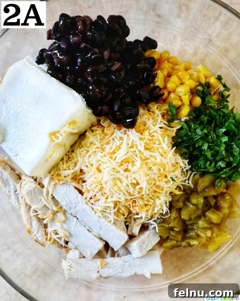 Delicious Leftover Turkey Enchilada Casserole 6 Bowls of shredded cheese, softened cream cheese, black beans, corn, and fresh herbs, ready for the enchilada filling.
